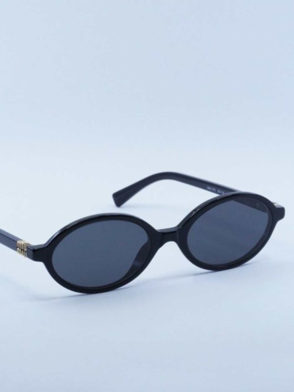 Miu Miu MU04ZS 1AB5S0 Sunglasses Black Oval Frame, Grey Lenses